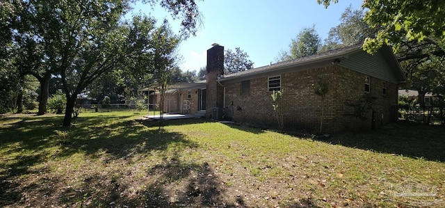 view of yard featuring a patio and central AC unit