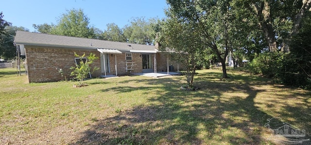 back of house featuring a yard