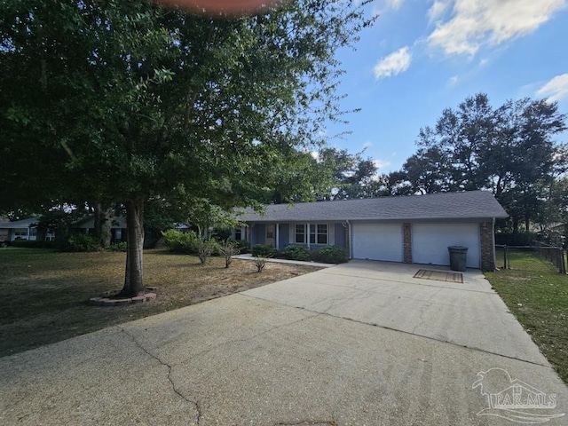 ranch-style house featuring a front yard and a garage