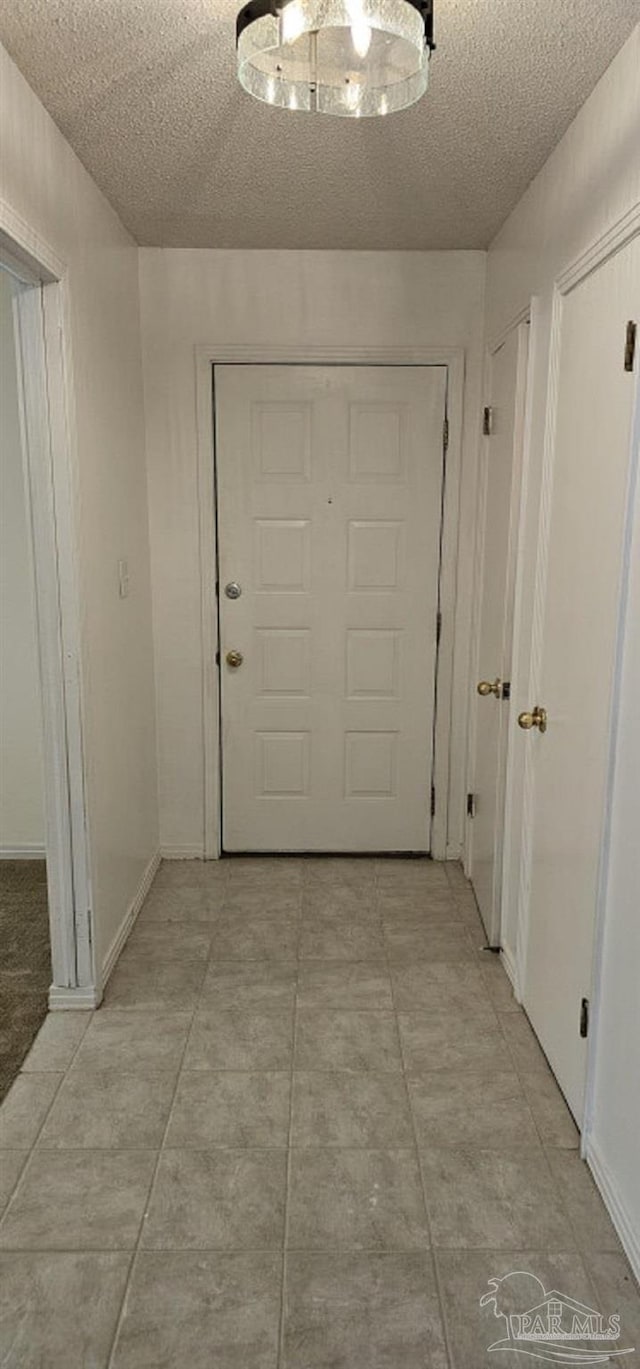 doorway featuring a textured ceiling