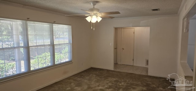 spare room with ceiling fan, crown molding, carpet, and a textured ceiling