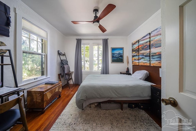 bedroom featuring multiple windows, ceiling fan, and dark wood-type flooring