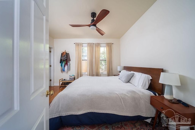 bedroom with dark hardwood / wood-style floors and ceiling fan