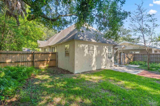 view of outbuilding featuring a lawn