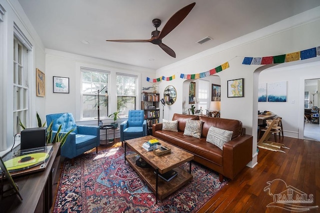 living room with ceiling fan, ornamental molding, and dark hardwood / wood-style flooring