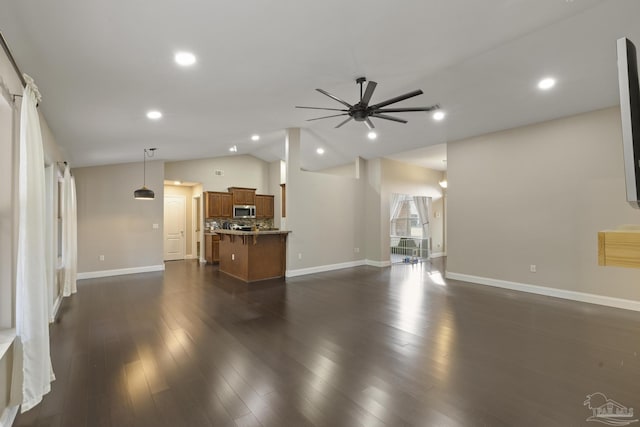 unfurnished living room featuring lofted ceiling, dark wood-type flooring, and ceiling fan