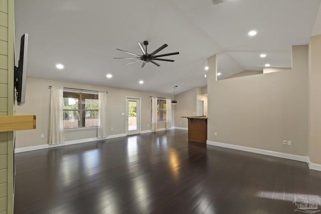 unfurnished living room featuring dark hardwood / wood-style flooring, lofted ceiling, and ceiling fan