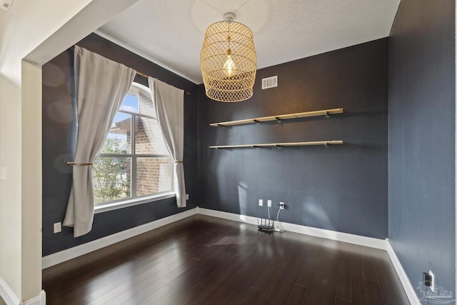unfurnished dining area featuring hardwood / wood-style floors and a notable chandelier