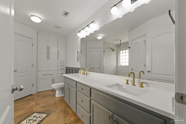 bathroom featuring vanity, toilet, and an enclosed shower