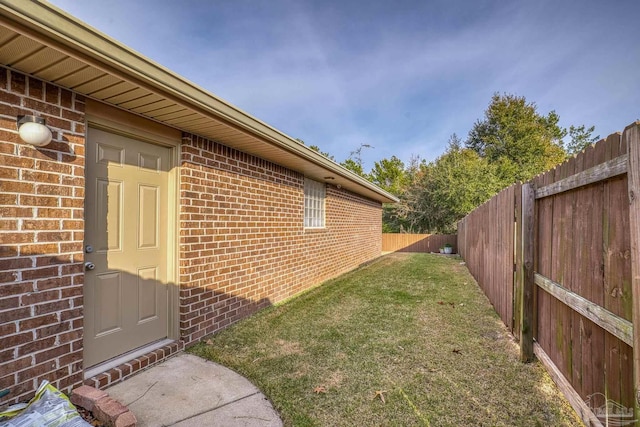 view of side of home featuring a yard