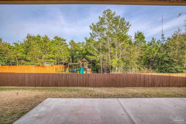 view of yard with a playground and a patio