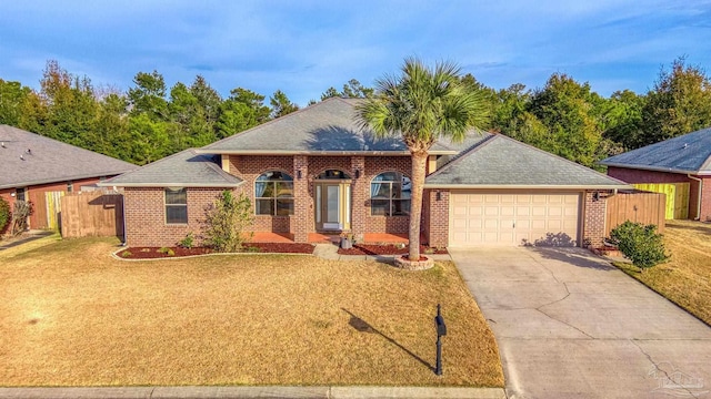 single story home featuring a garage and a front yard