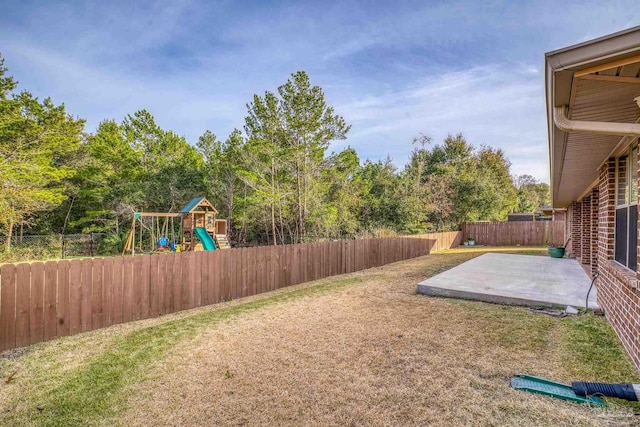 view of yard featuring a playground and a patio area