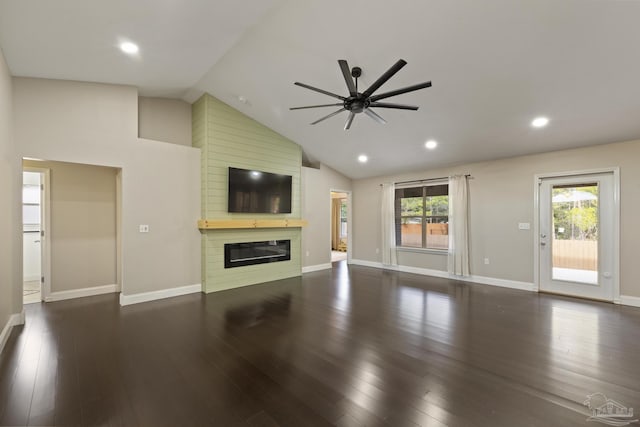 unfurnished living room with dark hardwood / wood-style flooring, lofted ceiling, ceiling fan, and a fireplace