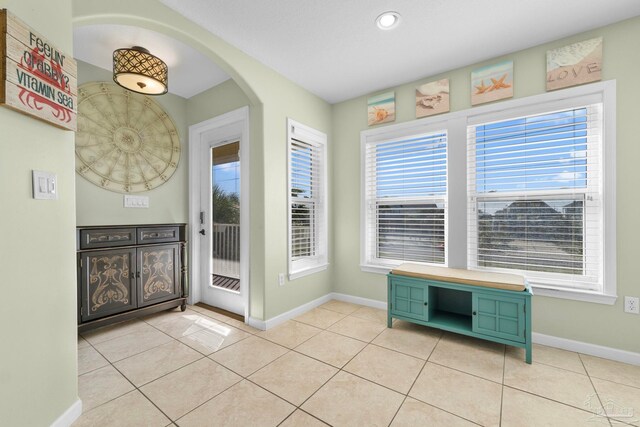 1113 Via Deluna Dr, Pensacola Beach, FL 32561 - entryway featuring baseboards, arched walkways, and a wealth of natural light