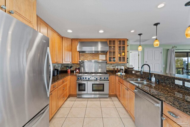 1113 Via Deluna Dr, Pensacola Beach, FL 32561 - kitchen featuring decorative backsplash, light tile patterned flooring, wall chimney range hood, a sink, and stainless steel appliances