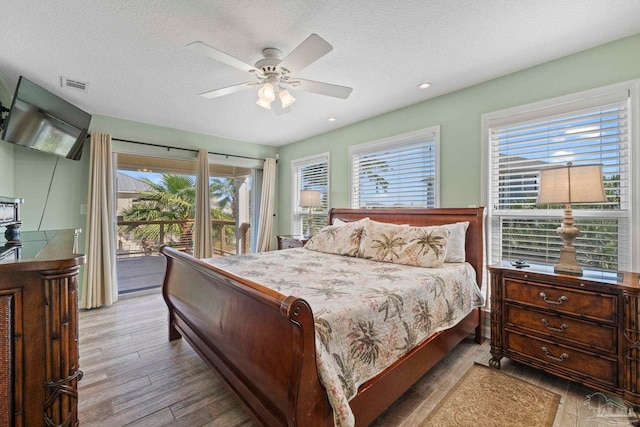 1113 Via Deluna Dr, Pensacola Beach, FL 32561 - bedroom featuring access to outside, multiple windows, wood finished floors, and visible vents