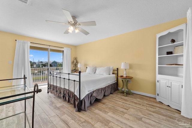 bedroom with light hardwood / wood-style flooring, access to exterior, and ceiling fan