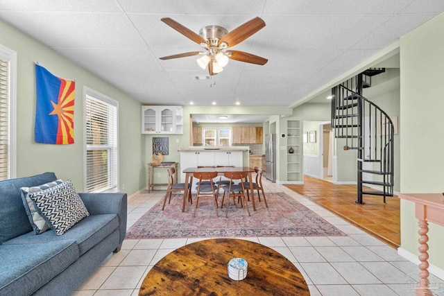 tiled dining space featuring ceiling fan