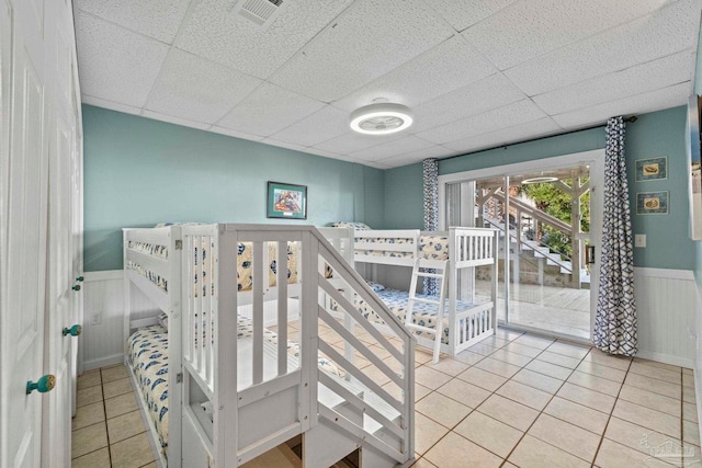 1113 Via Deluna Dr, Pensacola Beach, FL 32561 - interior space featuring tile patterned floors, visible vents, a paneled ceiling, and a wainscoted wall