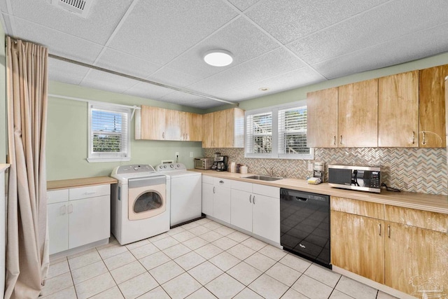 1113 Via Deluna Dr, Pensacola Beach, FL 32561 - kitchen featuring dishwasher, light countertops, stainless steel microwave, backsplash, and washing machine and dryer