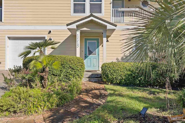 doorway to property with a garage