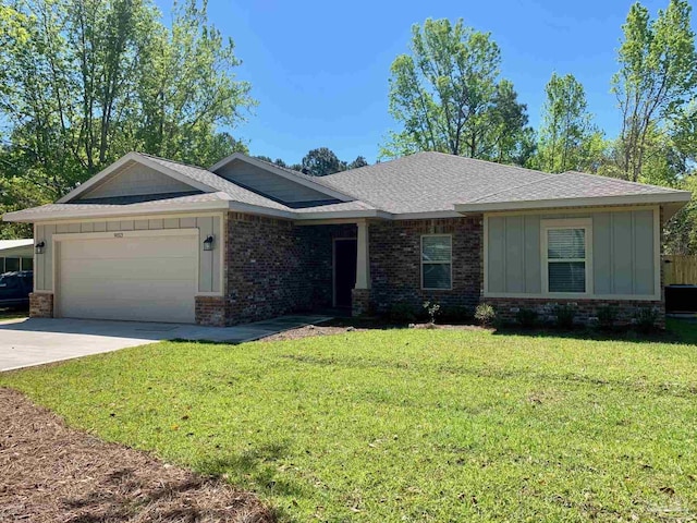 6621 Rocky Shores Rd, Milton, FL 32583 - view of front facade featuring board and batten siding, brick siding, a garage, and a front yard