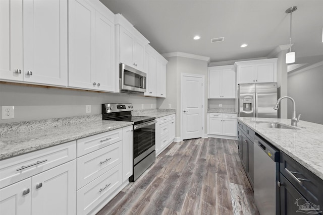 6621 Rocky Shores Rd, Milton, FL 32583 - kitchen with stainless steel appliances, ornamental molding, a sink, white cabinetry, and recessed lighting