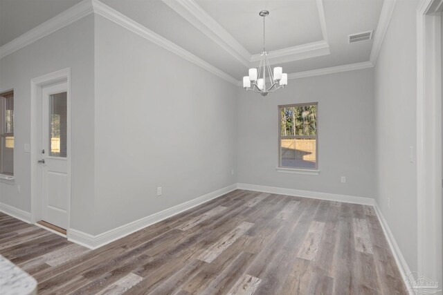 6621 Rocky Shores Rd, Milton, FL 32583 - empty room with wood finished floors, a chandelier, a tray ceiling, baseboards, and crown molding