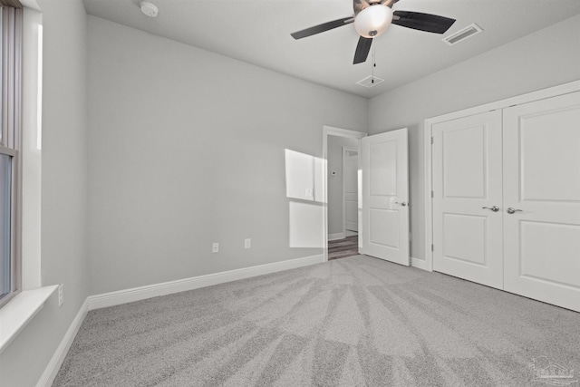 6621 Rocky Shores Rd, Milton, FL 32583 - unfurnished bedroom featuring carpet, baseboards, a closet, and ceiling fan