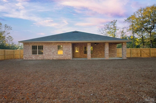 6621 Rocky Shores Rd, Milton, FL 32583 - rear view of property featuring a patio, a fenced backyard, a shingled roof, and brick siding