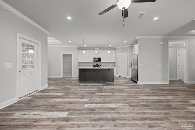 6621 Rocky Shores Rd, Milton, FL 32583 - unfurnished living room with ornamental molding, recessed lighting, a ceiling fan, baseboards, and wood finished floors