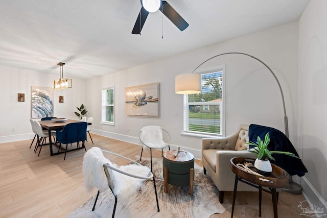 living area with a healthy amount of sunlight, light wood-type flooring, and baseboards