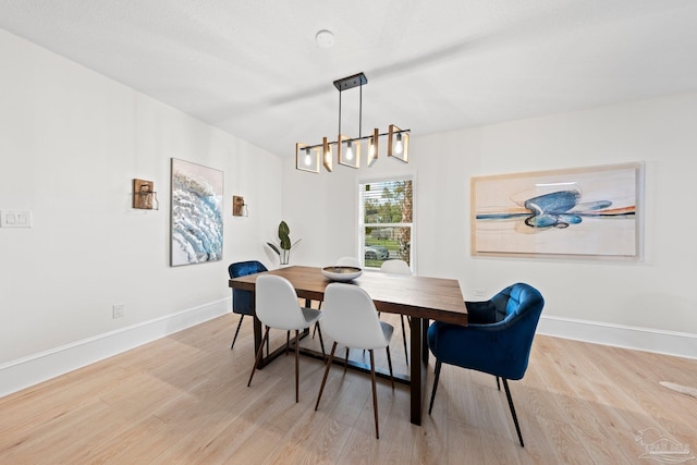 2512 N 8th Ave, Pensacola, FL 32503 - dining space with a chandelier, wood finished floors, and baseboards