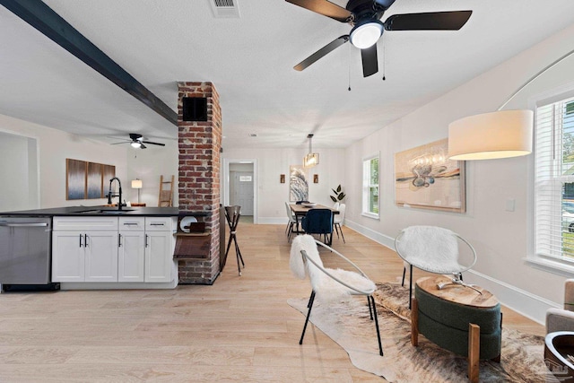 interior space featuring baseboards, a textured ceiling, visible vents, and light wood-style floors