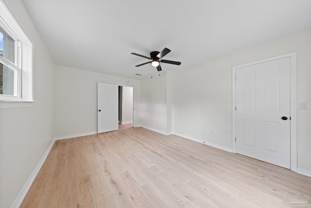 spare room featuring light wood-style flooring and baseboards