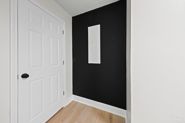 unfurnished room featuring light wood-style flooring and baseboards