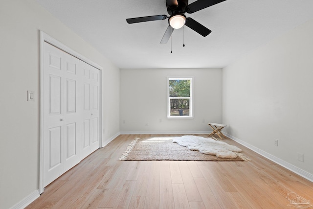 unfurnished bedroom featuring ceiling fan, wood finished floors, and baseboards