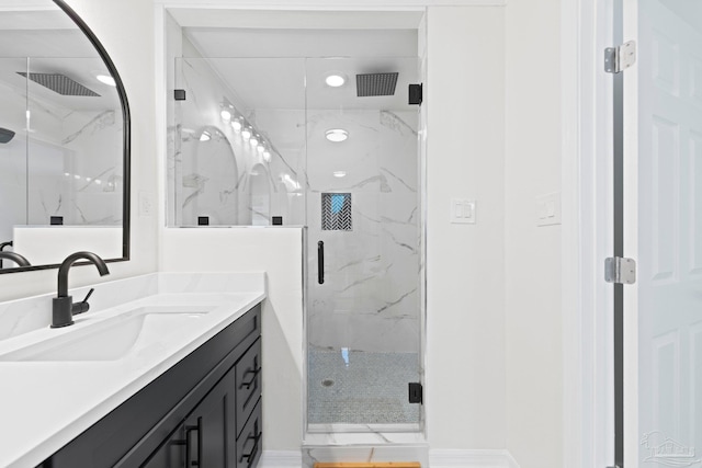 bathroom featuring a marble finish shower, visible vents, and vanity