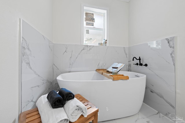 2512 N 8th Ave, Pensacola, FL 32503 - full bath with tile walls, marble tiled floors, a freestanding tub, and a wainscoted wall