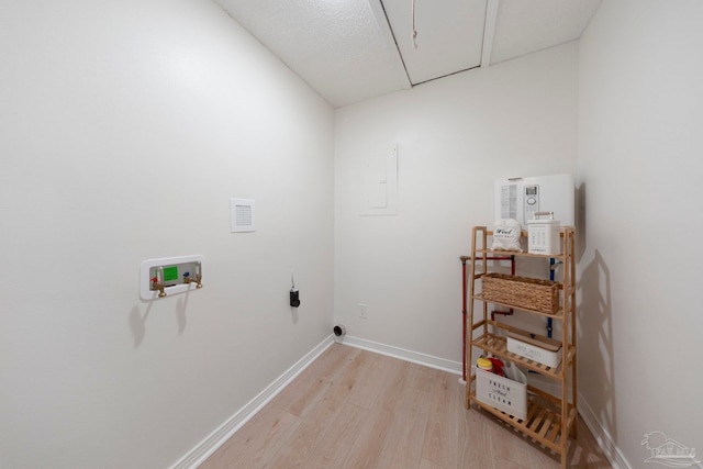 clothes washing area featuring laundry area, washer hookup, baseboards, light wood-type flooring, and attic access