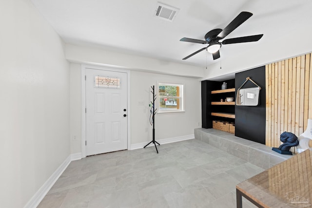 entrance foyer featuring a ceiling fan, visible vents, and baseboards