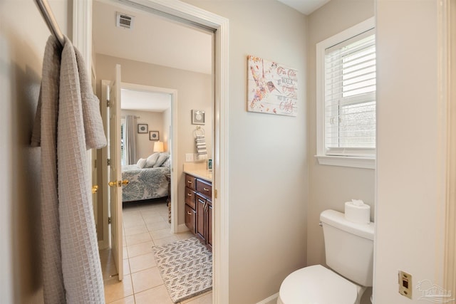 9638 Wills Ln, Lillian, AL 36549 - full bathroom with tile patterned floors, toilet, ensuite bathroom, and vanity