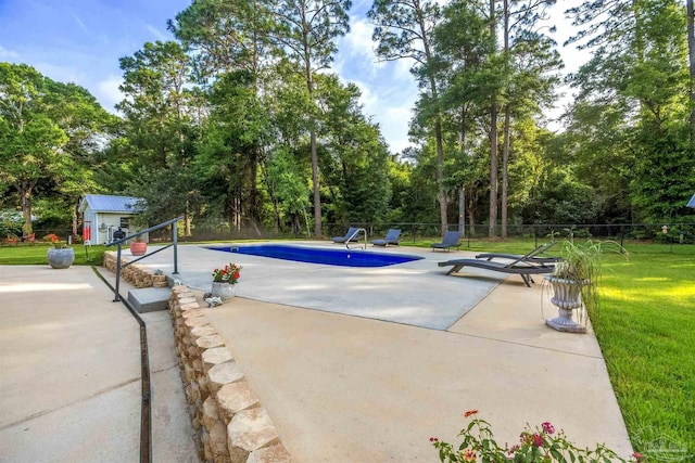 9638 Wills Ln, Lillian, AL 36549 - view of pool featuring a patio, an outbuilding, and view of wooded area