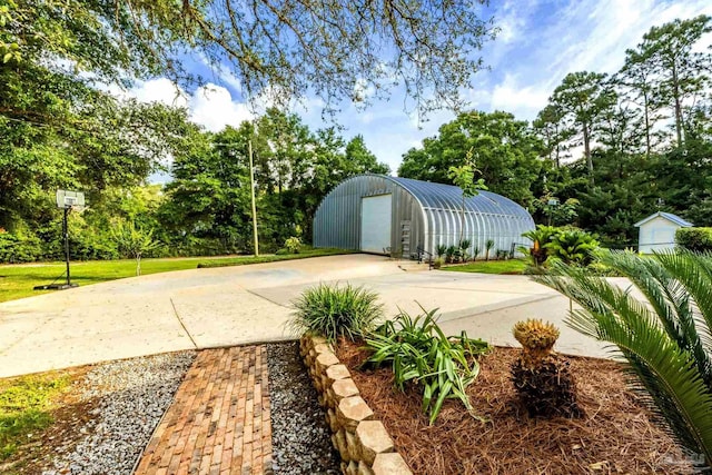 9638 Wills Ln, Lillian, AL 36549 - view of yard featuring an outdoor structure, concrete driveway, and view of scattered trees