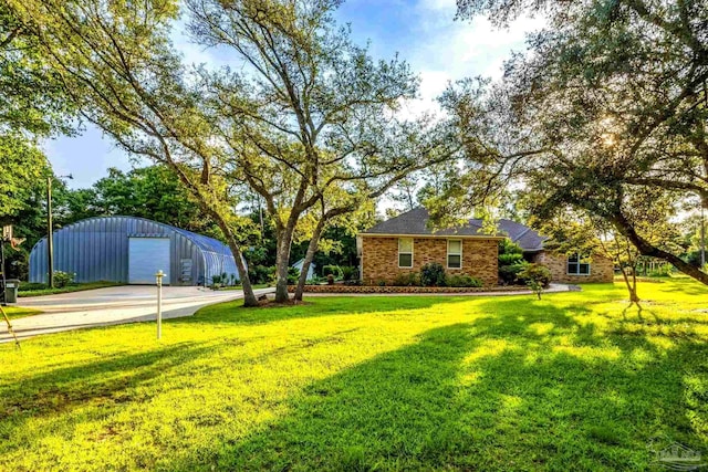 9638 Wills Ln, Lillian, AL 36549 - view of grassy yard with an outdoor structure, a detached garage, and concrete driveway