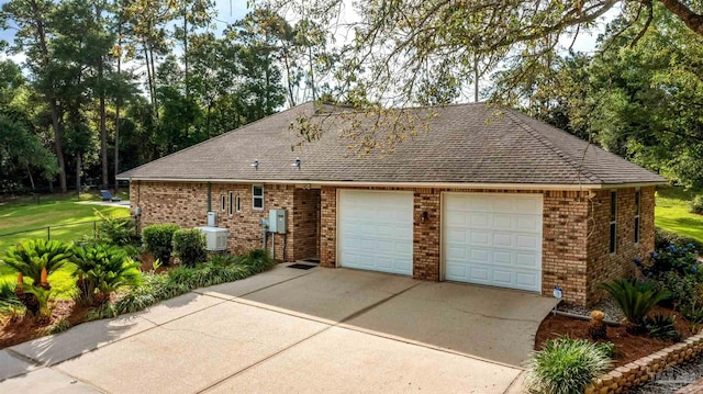 9638 Wills Ln, Lillian, AL 36549 - view of property exterior with brick siding, roof with shingles, a garage, and driveway