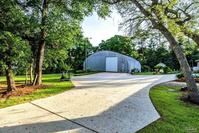9638 Wills Ln, Lillian, AL 36549 - view of outdoor structure featuring concrete driveway and view of scattered trees