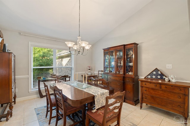 9638 Wills Ln, Lillian, AL 36549 - dining room with lofted ceiling, a chandelier, light tile patterned flooring, and baseboards
