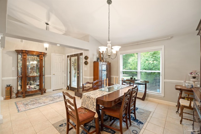 9638 Wills Ln, Lillian, AL 36549 - dining space with light tile patterned floors, a chandelier, vaulted ceiling, and baseboards